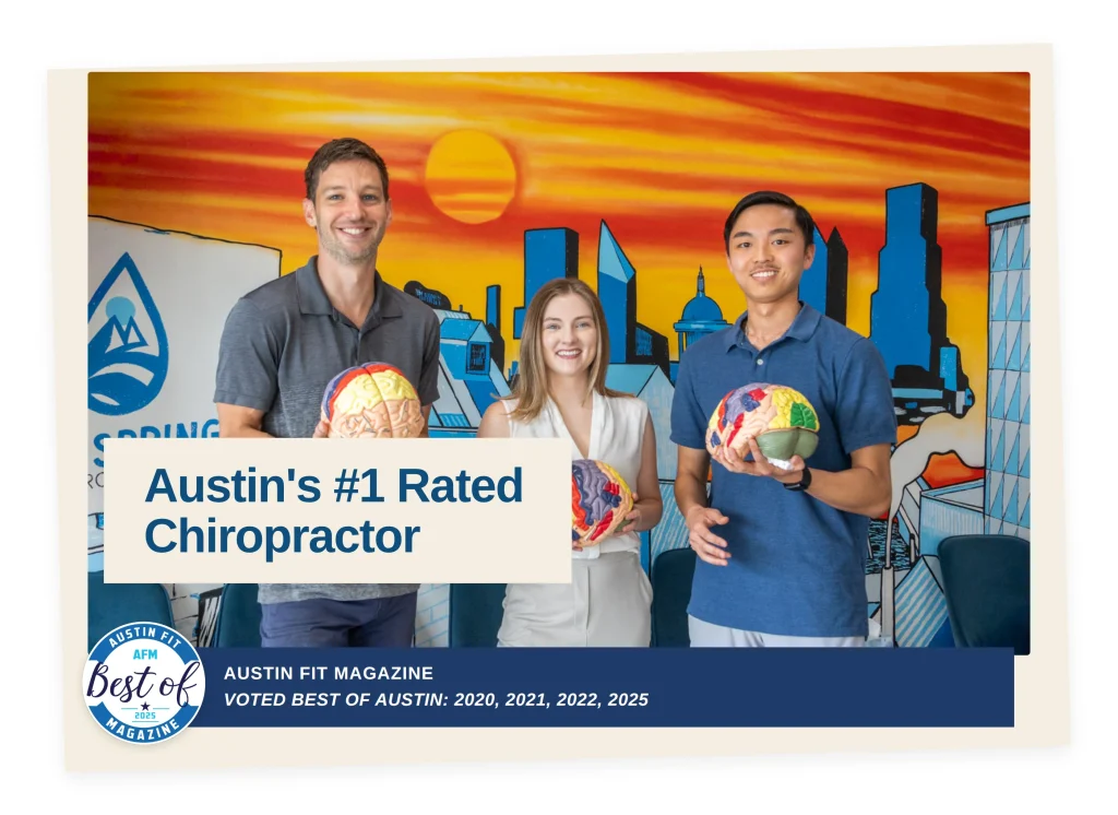 Lifespring Chiropractic team holding brain models in their South Austin office, recognized as Austin's #1 rated chiropractor and voted Best of Austin by Austin Fit Magazine in 2020, 2021, 2022, and 2025.